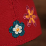 Close up of the wearer's left crotched flowers on the Philadelphia Phillies All Over Floral Pattern Flower Crotchet Side Patch Pink Bottom 59Fifty Fitted Cap