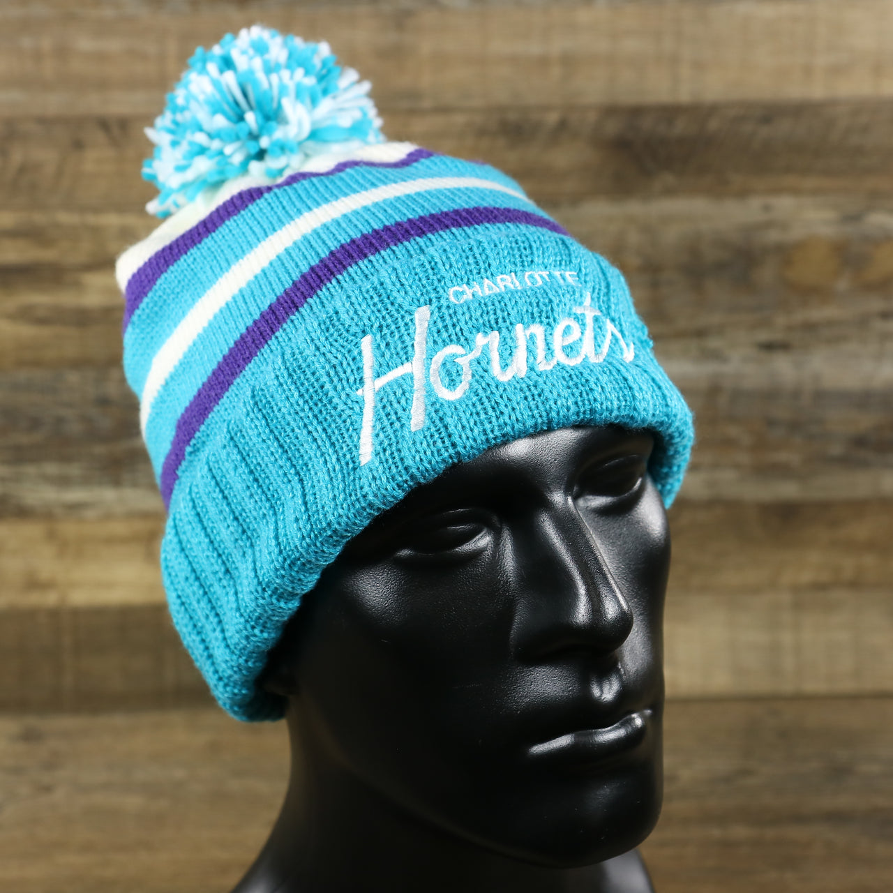The Charlotte Hornets Cursive Wordmark Teal Blue Cuff Pom Pom Winter Beanie | Teal Blue Striped Winter Beanie