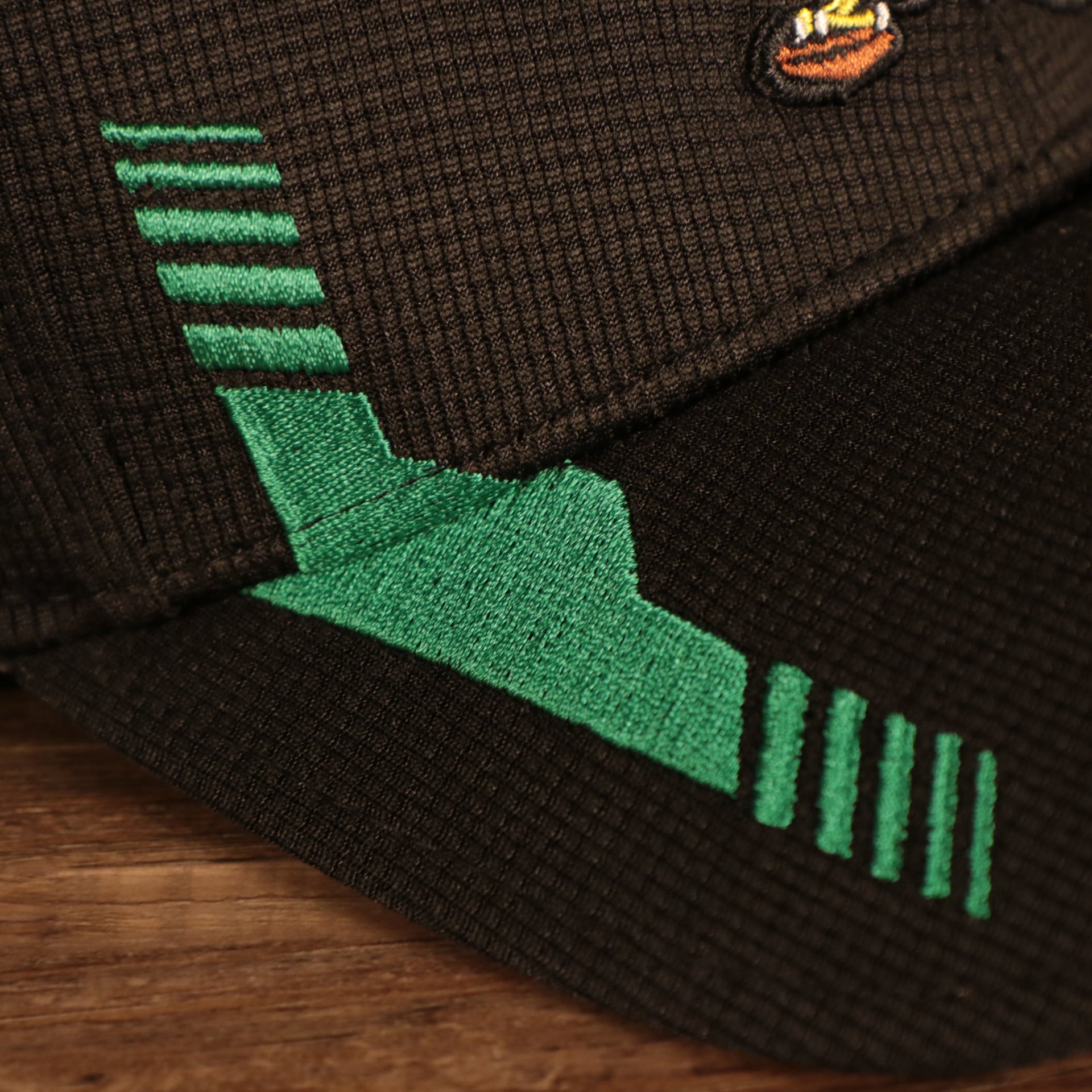 Racing stripes on the Philadelphia Eagles 2021 Sideline On-Field Throwback Logo 39Thirty Stretch Cap