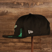 Wearer's left of the Philadelphia Eagles 2021 Sideline On-Field Throwback Logo 9Fifty Snapback Hat