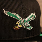 Close up of throwback Eagles logo on the Philadelphia Eagles 2021 Sideline On-Field Throwback Logo 9Fifty Snapback Hat