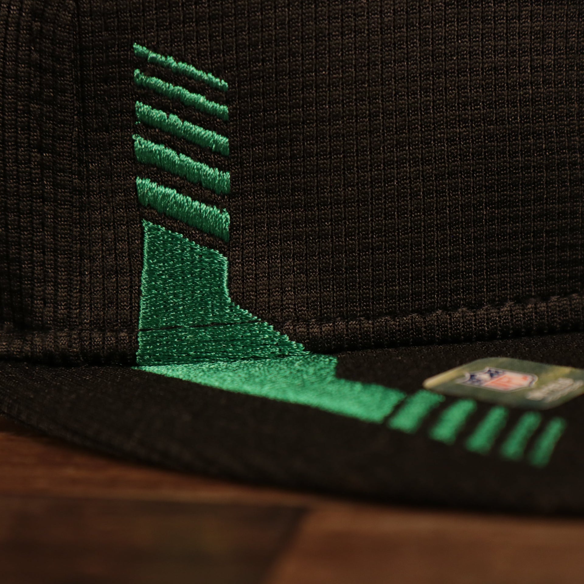 Close up of racing stripe on Philadelphia Eagles 2021 Sideline On-Field Throwback Logo 9Fifty Snapback Hat