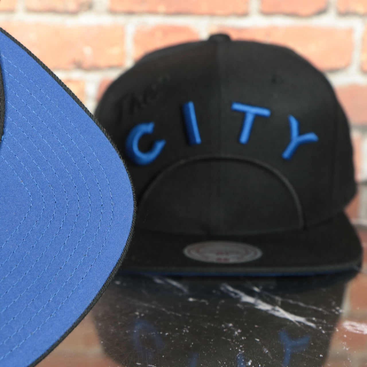 blue under visor on the Golden State Warriors XL Logo Black Mitchell and Ness Snapback Hat