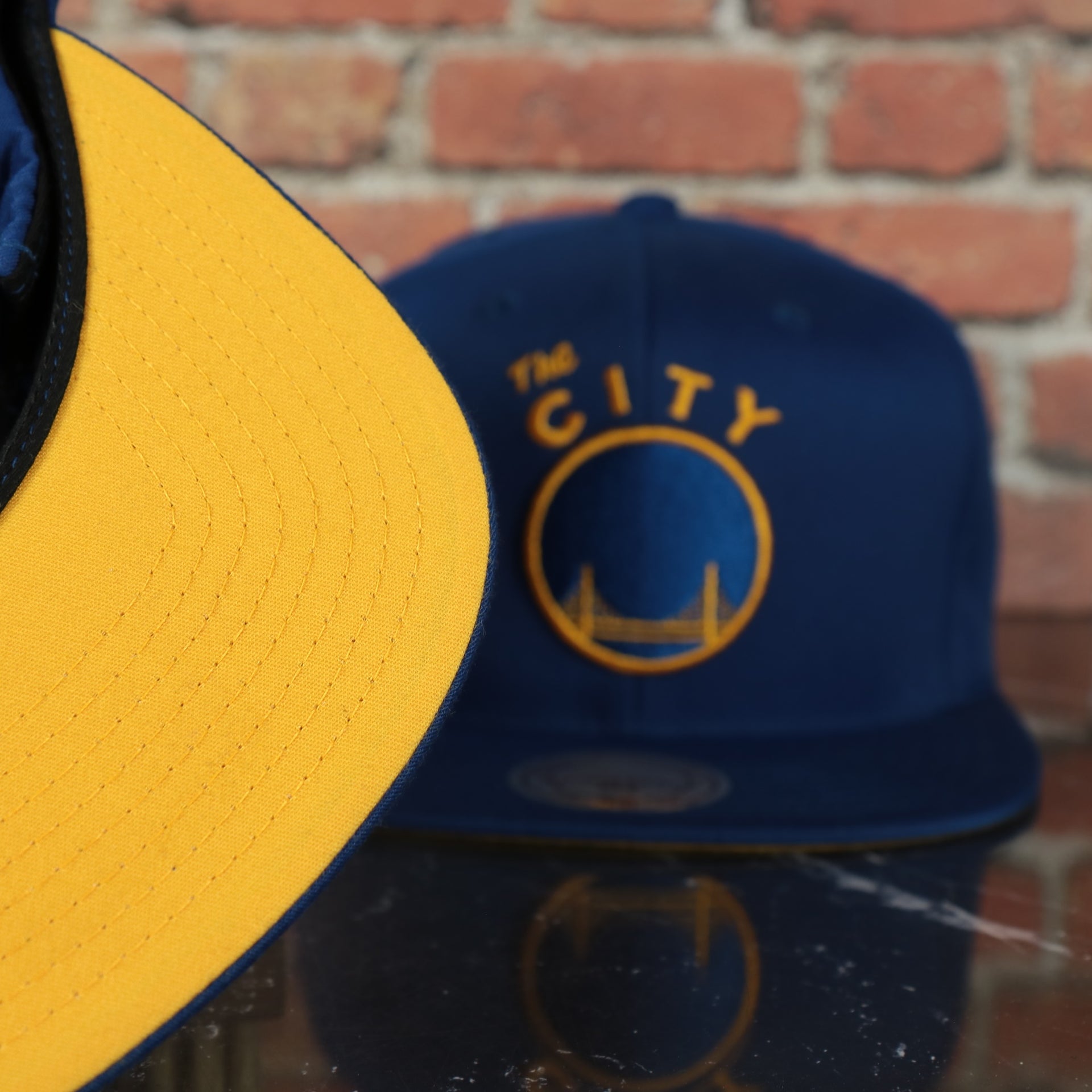 yellow under visor on the Golden State Warriors Mitchell and Ness Perforated Snapback Hat