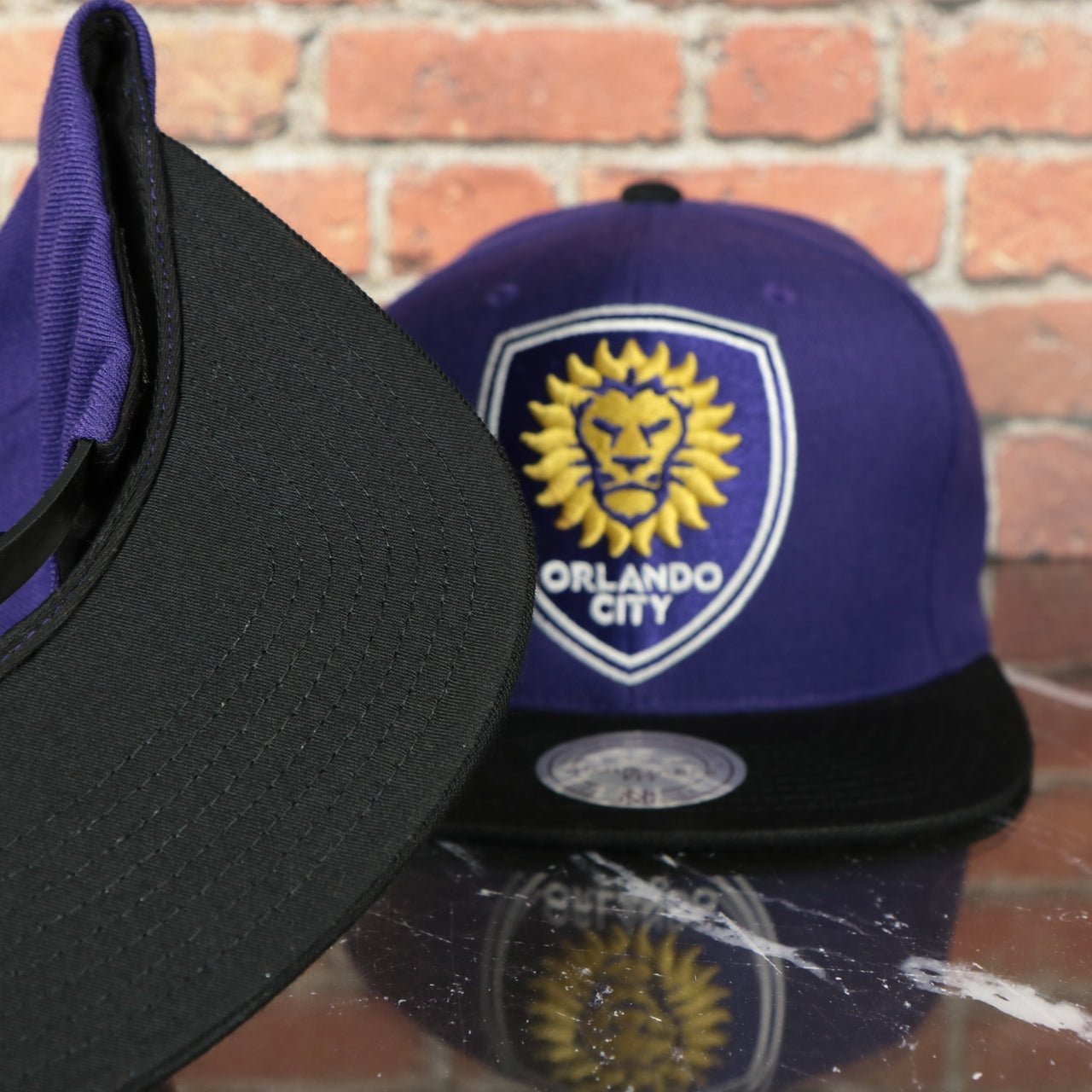 black under visor on the Orlando City Lions XL Logo Two Tone Purple on Black Snapback Hat