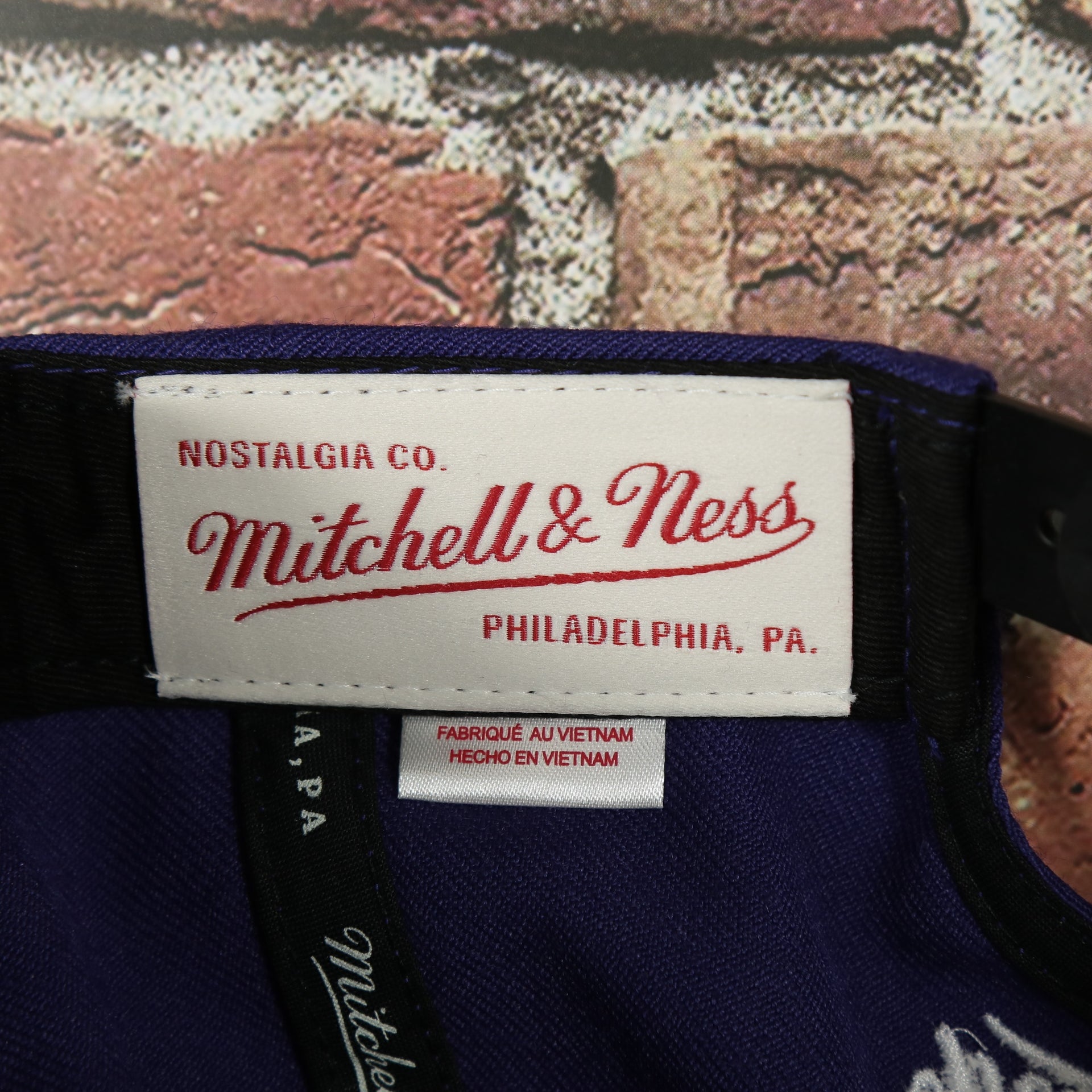 mitchell and ness label on the Orlando City Lions XL Logo Two Tone Purple on Black Snapback Hat