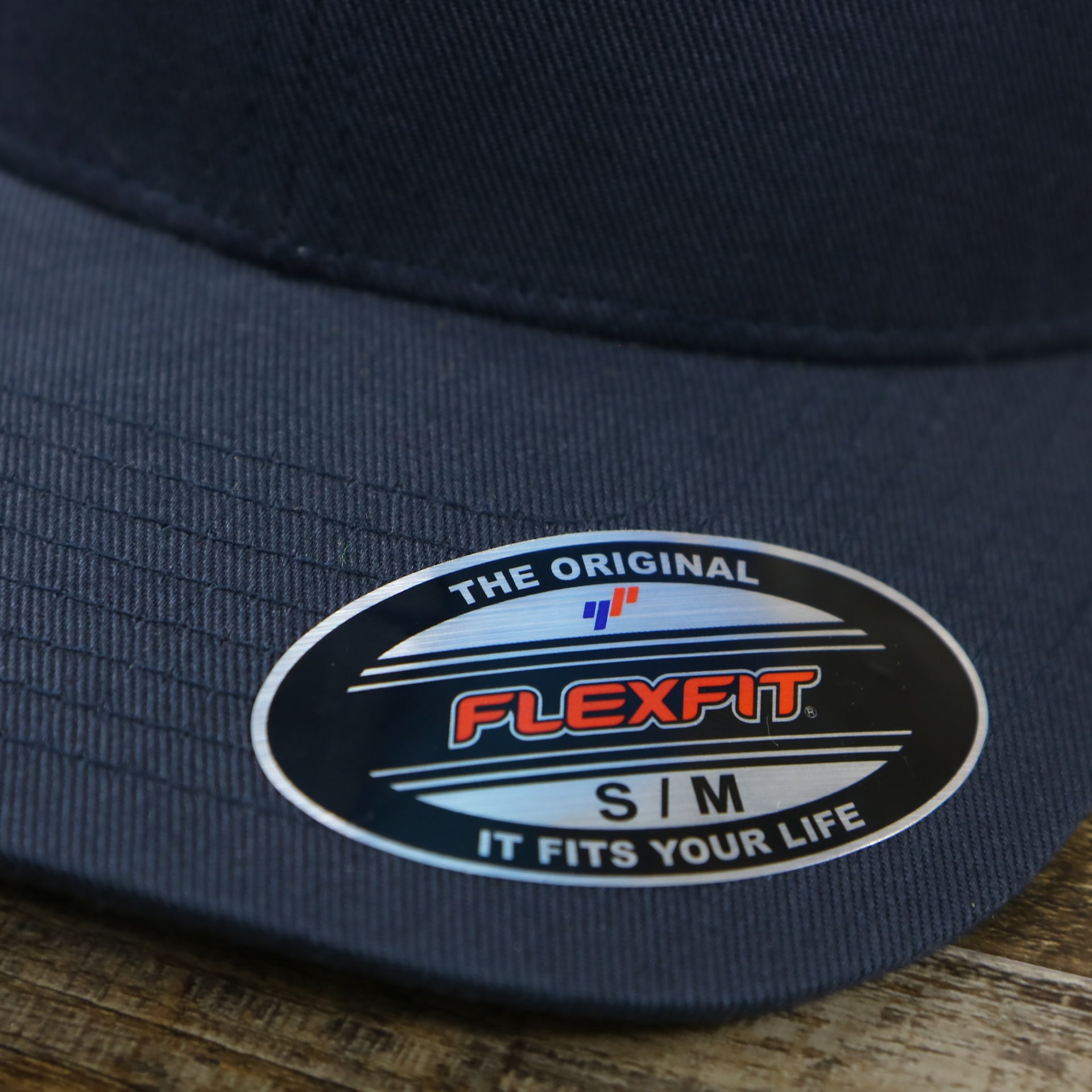 The Flexfit Tag on the Jet Black Bent Brim Silver Bottom Blank FlexFit Cap | Black Flex Cap