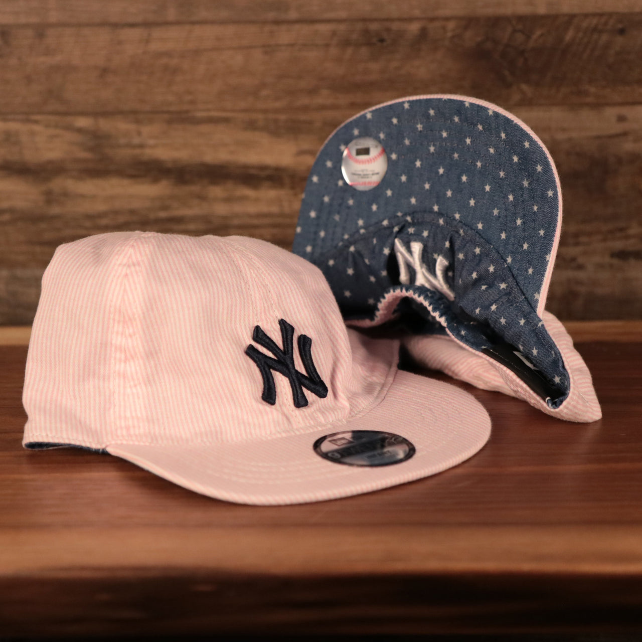 front and bottom of the New York Yankees Reversible Navy & Pink Infant 9Twenty Dad Hat