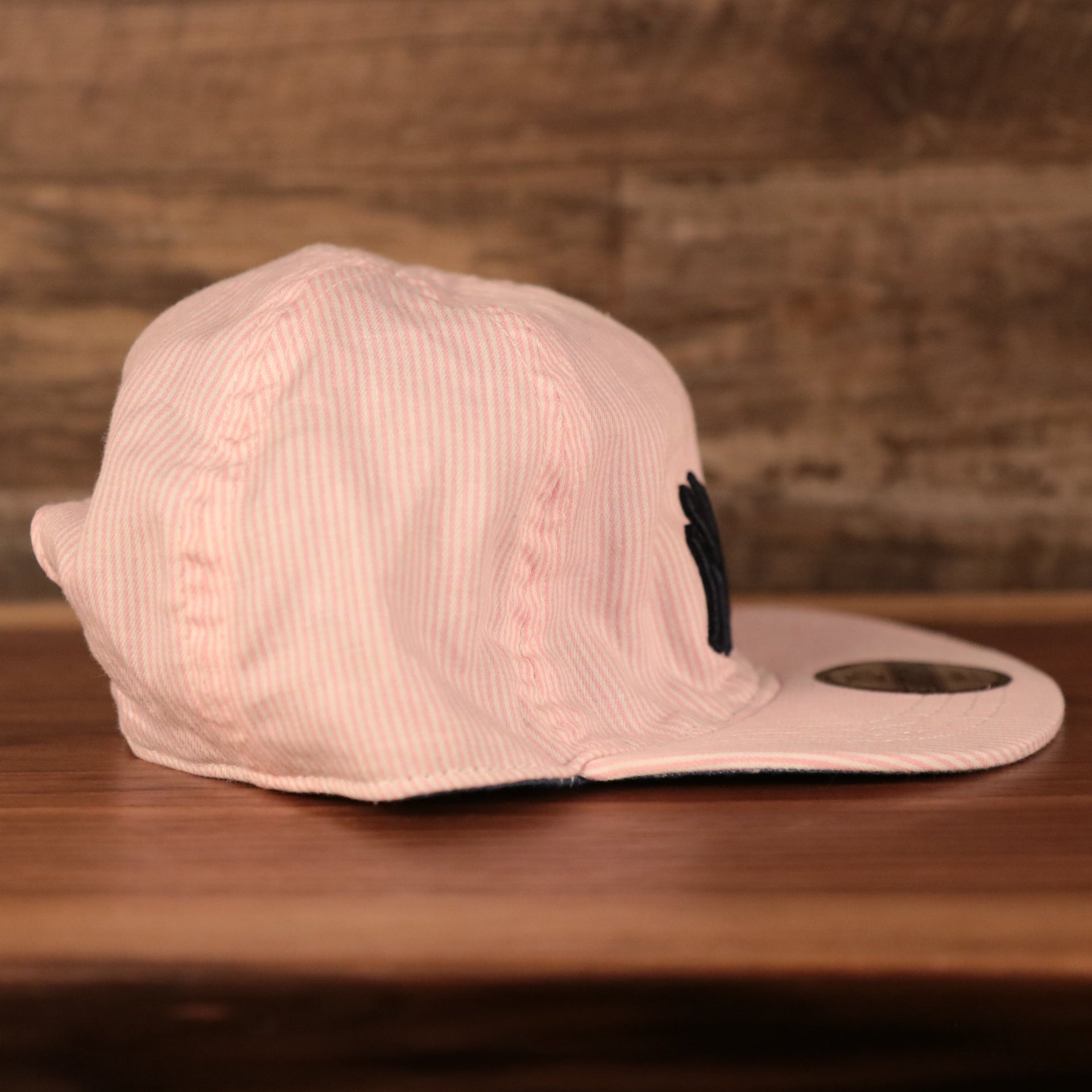 wearers right side of the New York Yankees Reversible Navy & Pink Infant 9Twenty Dad Hat