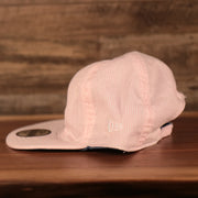 wearers left side of the New York Yankees Reversible Navy & Pink Infant 9Twenty Dad Hat