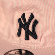 yankees logo on the front of the New York Yankees Reversible Navy & Pink Infant 9Twenty Dad Hat