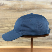 The wearer's left of the Youth Navy Blue Flat Brim Blank Baseball Hat | Kid’s Dark Blue Dad Hat