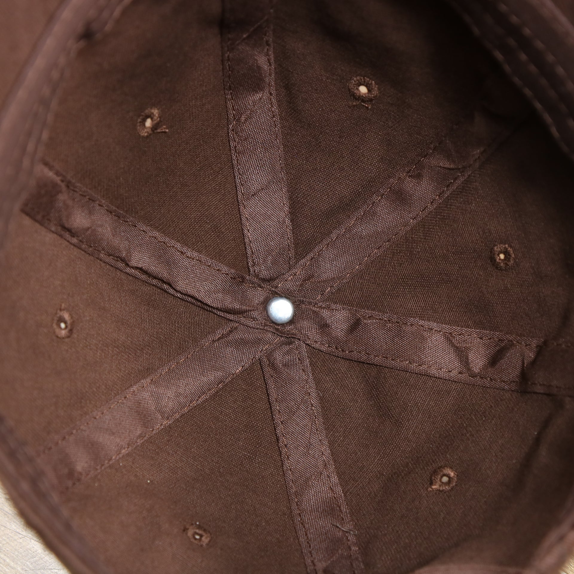 The inside of the Chocolate Bent Brim Blank Baseball Hat | Brown Dad Hat