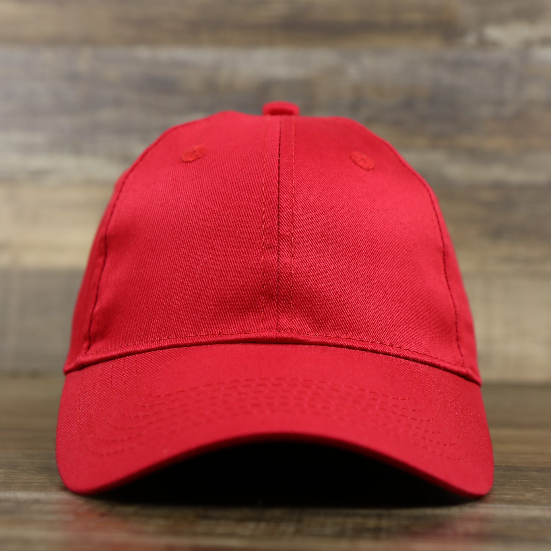The front of the Youth Cardinal Red Flat Brim Blank Baseball Hat | Kid’s Red Dad Hat
