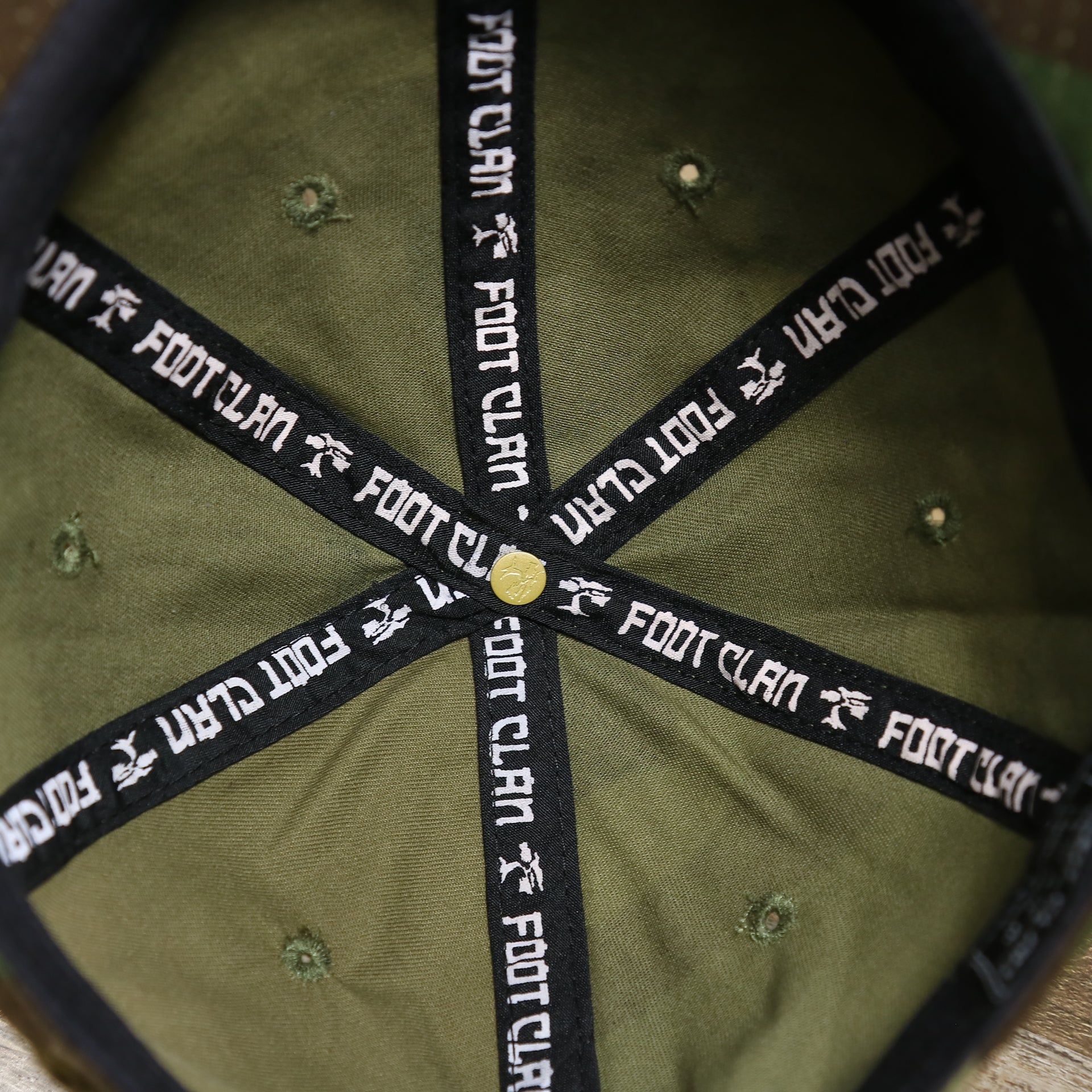 The inside of the Forest Camo Bent Brim Distressed Blank Baseball Hat | Dark Green Dad Hat