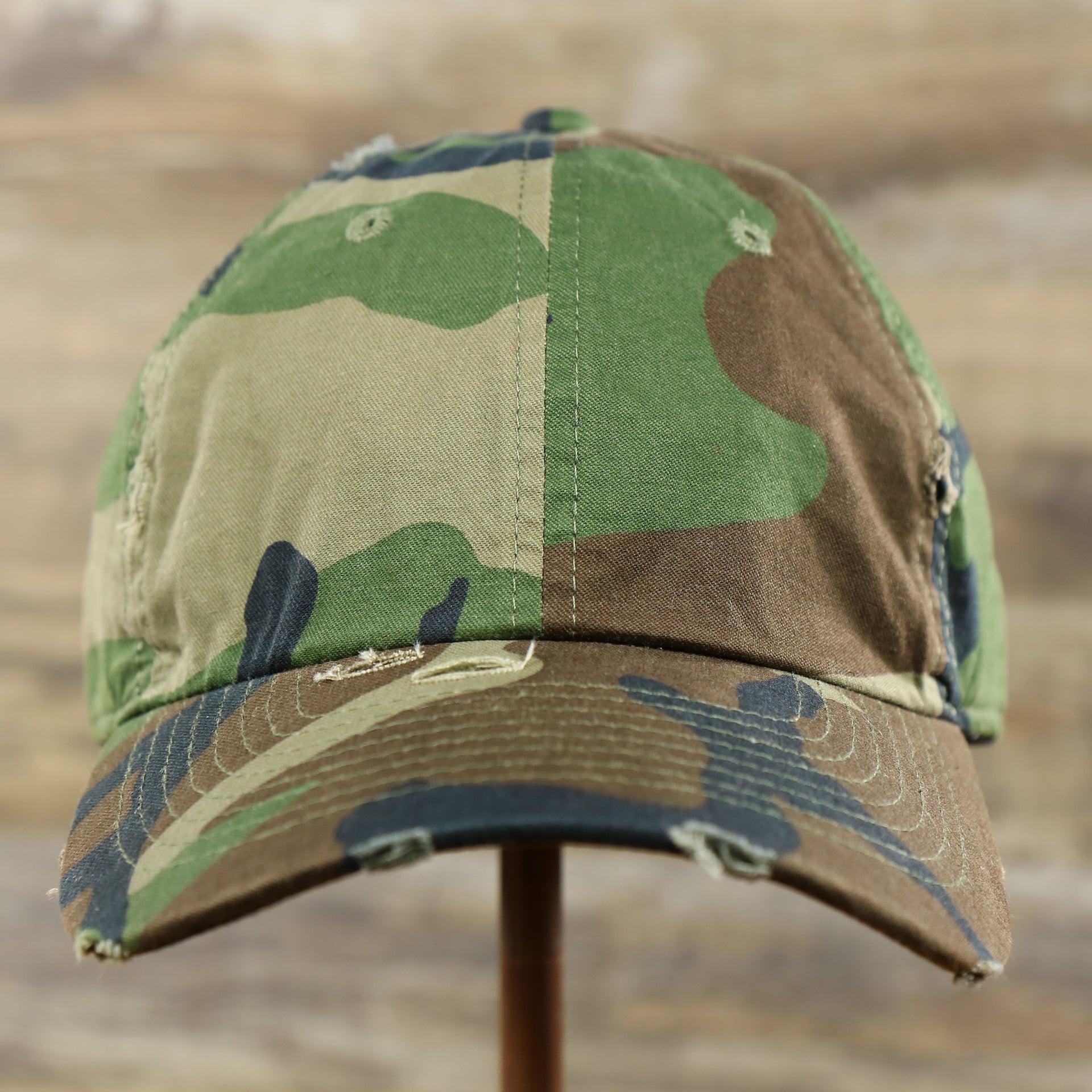 The front of the Forest Camo Bent Brim Distressed Blank Baseball Hat | Dark Green Dad Hat