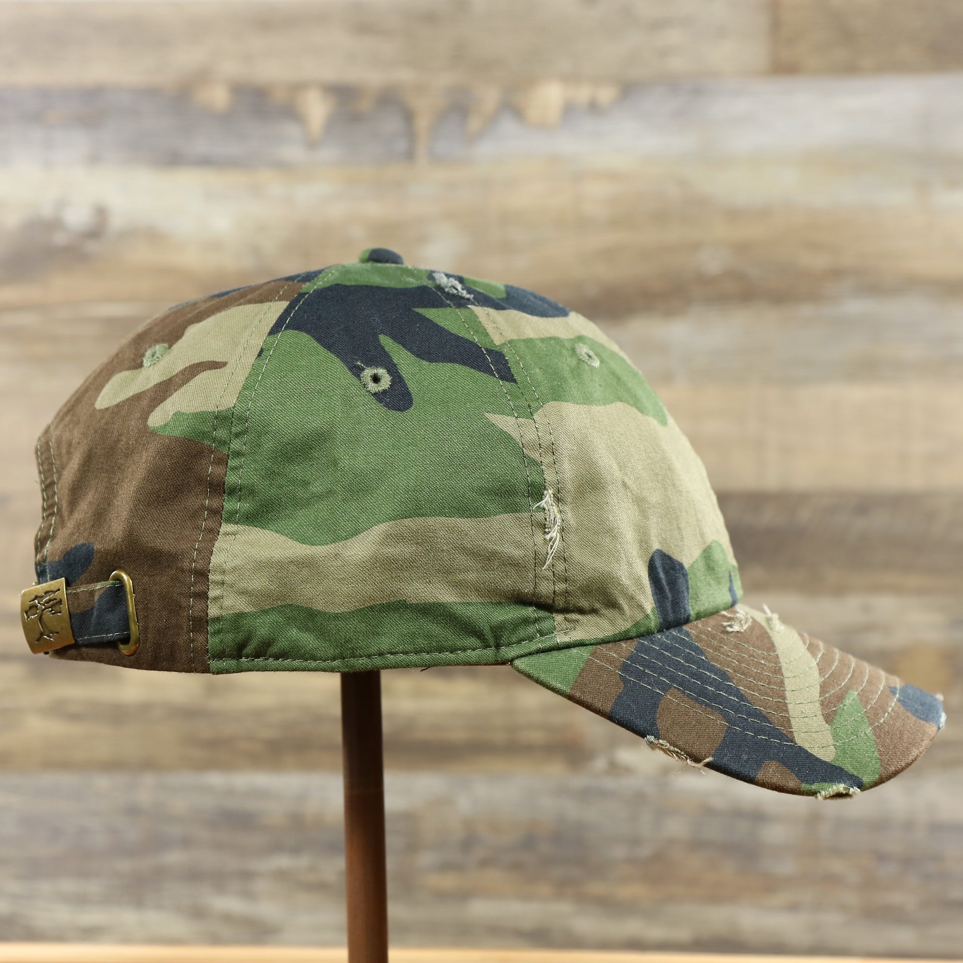 The wearer's right on the Forest Camo Bent Brim Distressed Blank Baseball Hat | Dark Green Dad Hat