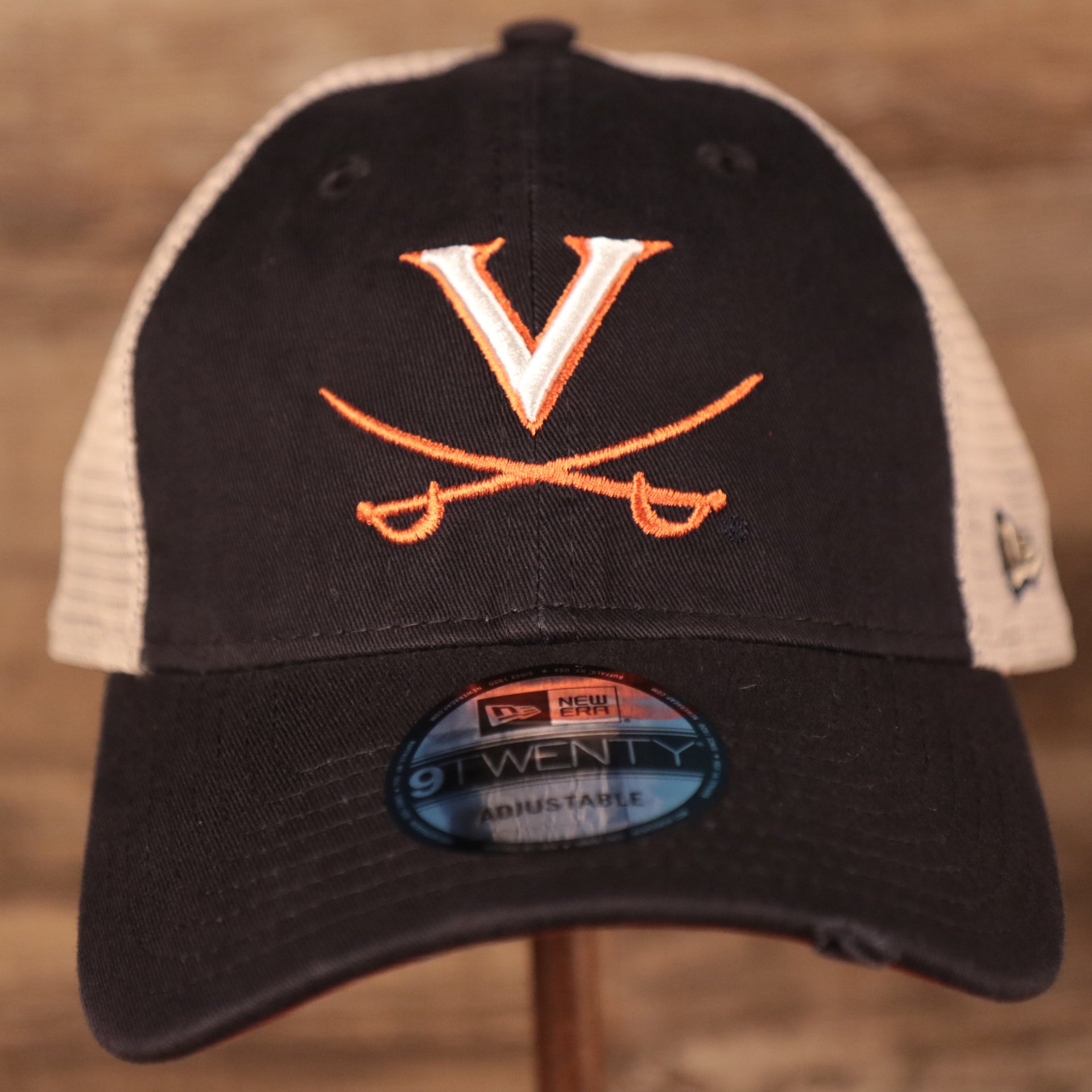 front of the Virginia Cavaliers Navy Adjustable Orange Bottom Distressed Trucker Cap