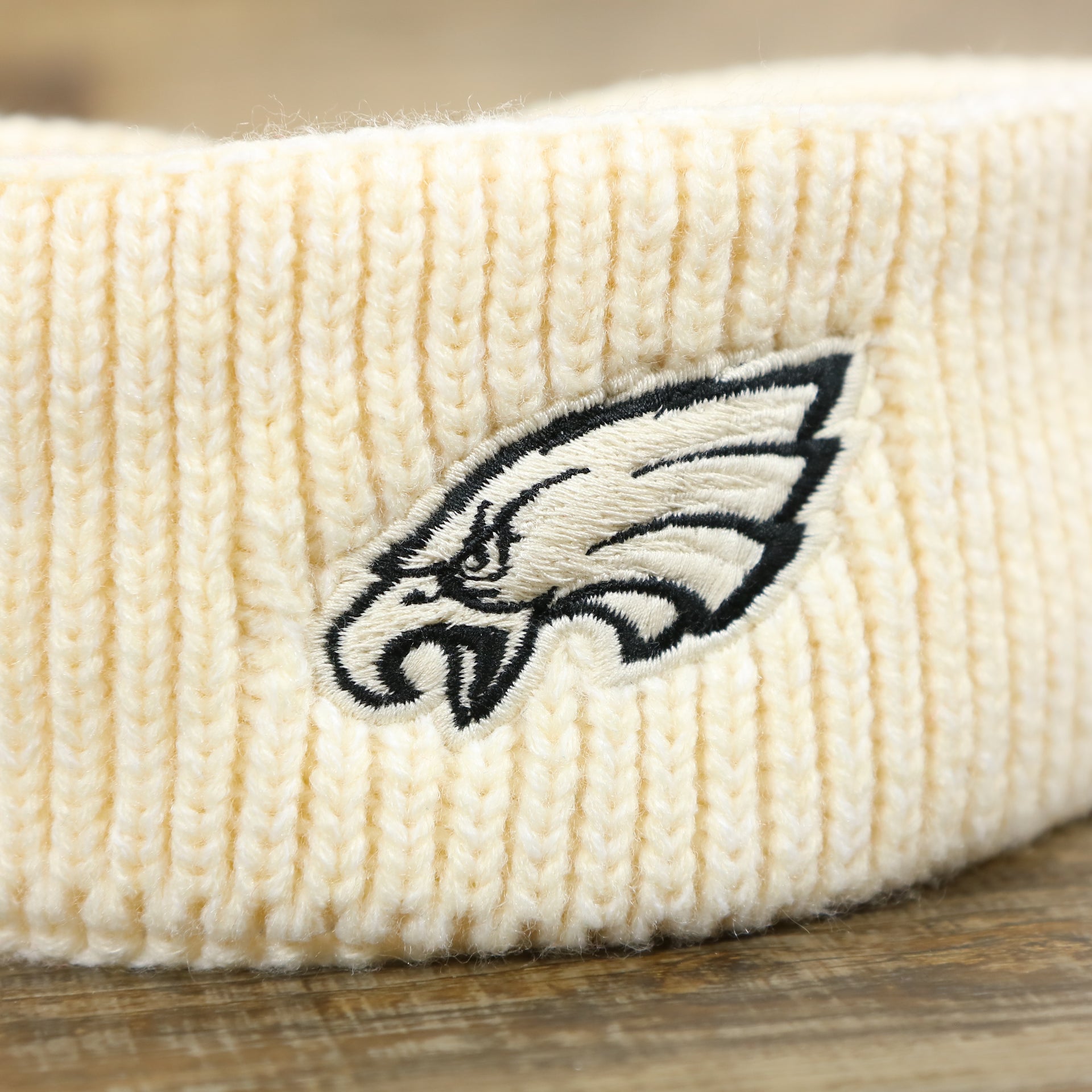The Eagles Logo on the Women’s Philadelphia Eagles Winter Knit Cream Twisted Headband | White Twisted Headband