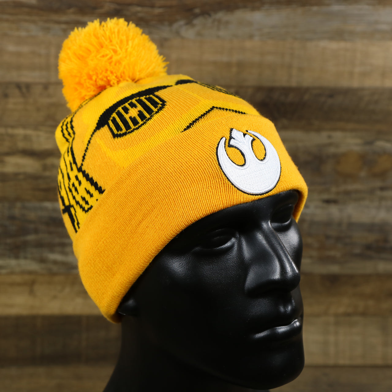The C3PO Rebel Alliance Cuffed Logo Winter Beanie With Pom Pom | Yellow Winter Beanie on a mannequin
