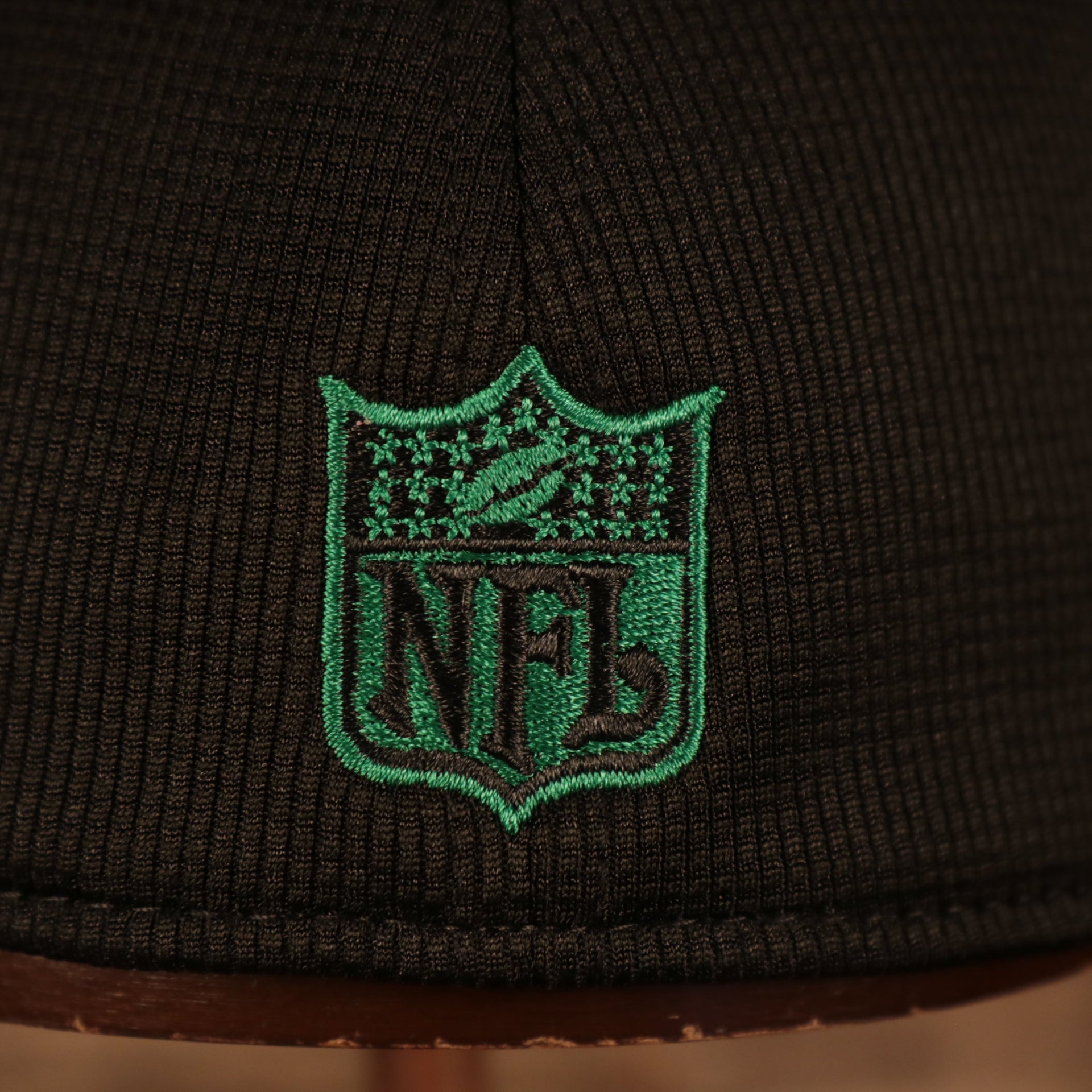 Close up of the vintage NFL shield embroidered on Philadelphia Eagles 2021 Sideline On-Field Throwback Logo 39Thirty Stretch Cap