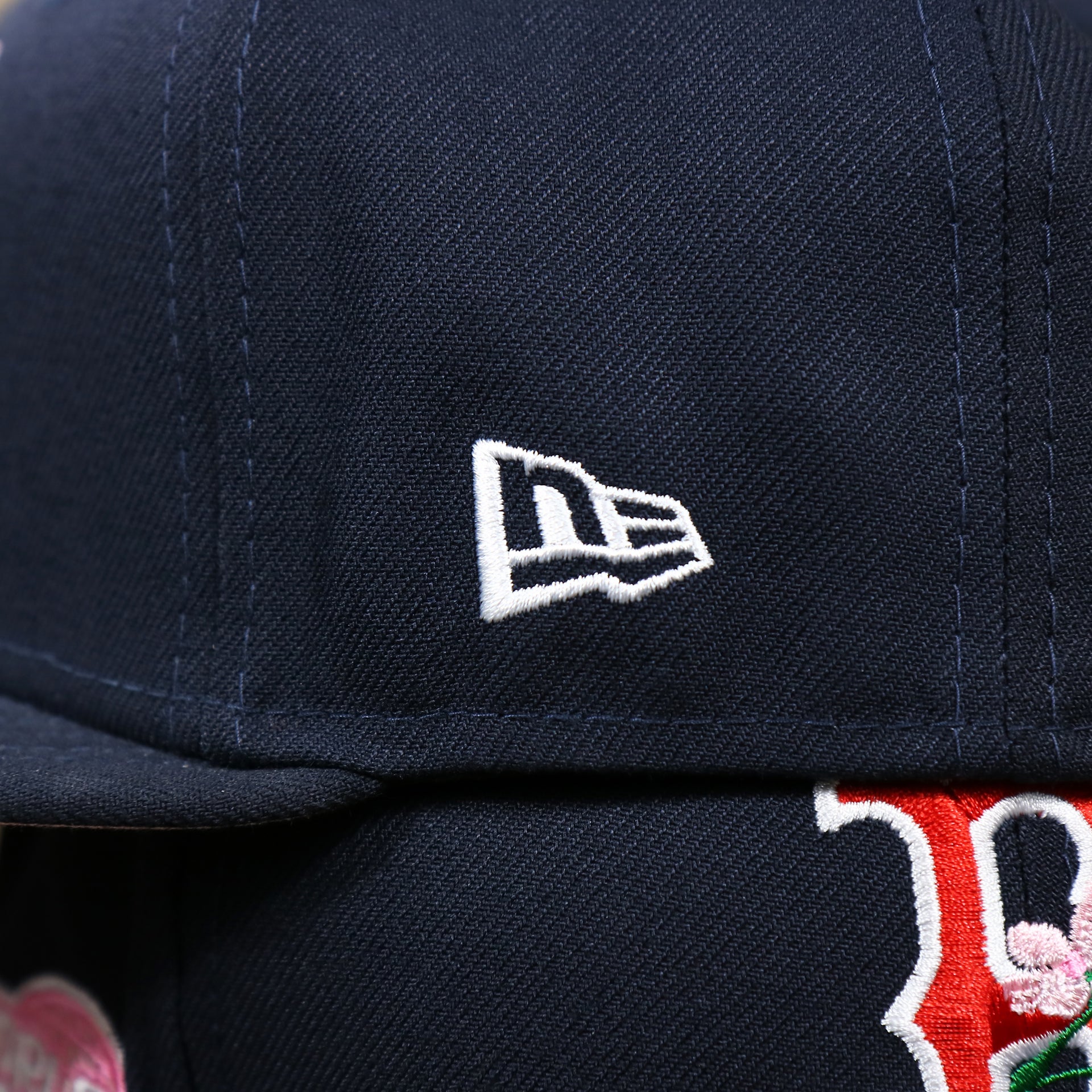 The New Era Logo on the Boston Red Sox Pink Undervisor Sakura Tree Embroidered 59Fifty Fitted Cap | Navy Blue 59Fifty Cap