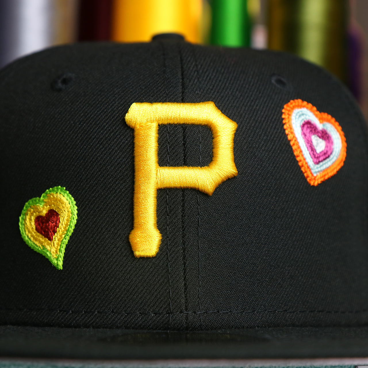 The Pirates Logo on the Pittsburgh Pirates All Over Embroidered Chain Stitch Heart Pink Bottom 59Fifty Fitted Cap | Black 59Fifty Cap