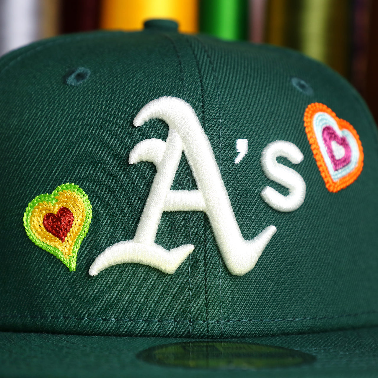 The Athletics Logo on the Oakland Athletics All Over Embroidered Chain Stitch Heart Pink Bottom 59Fifty Fitted Cap | Green 59Fifty Cap