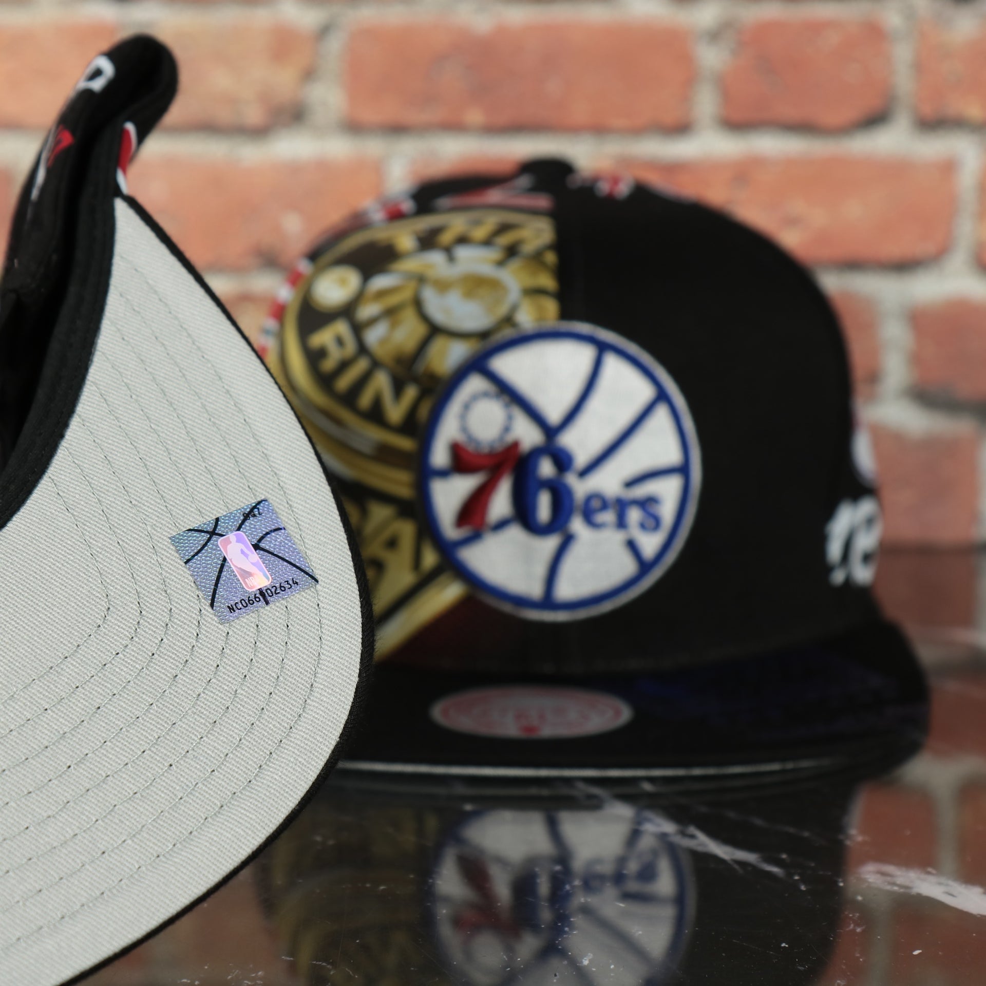 grey under visor on the Philadelphia 76ers “NBA Shirt Remix” All Over Print NBA Finals Champions Snapback Hat