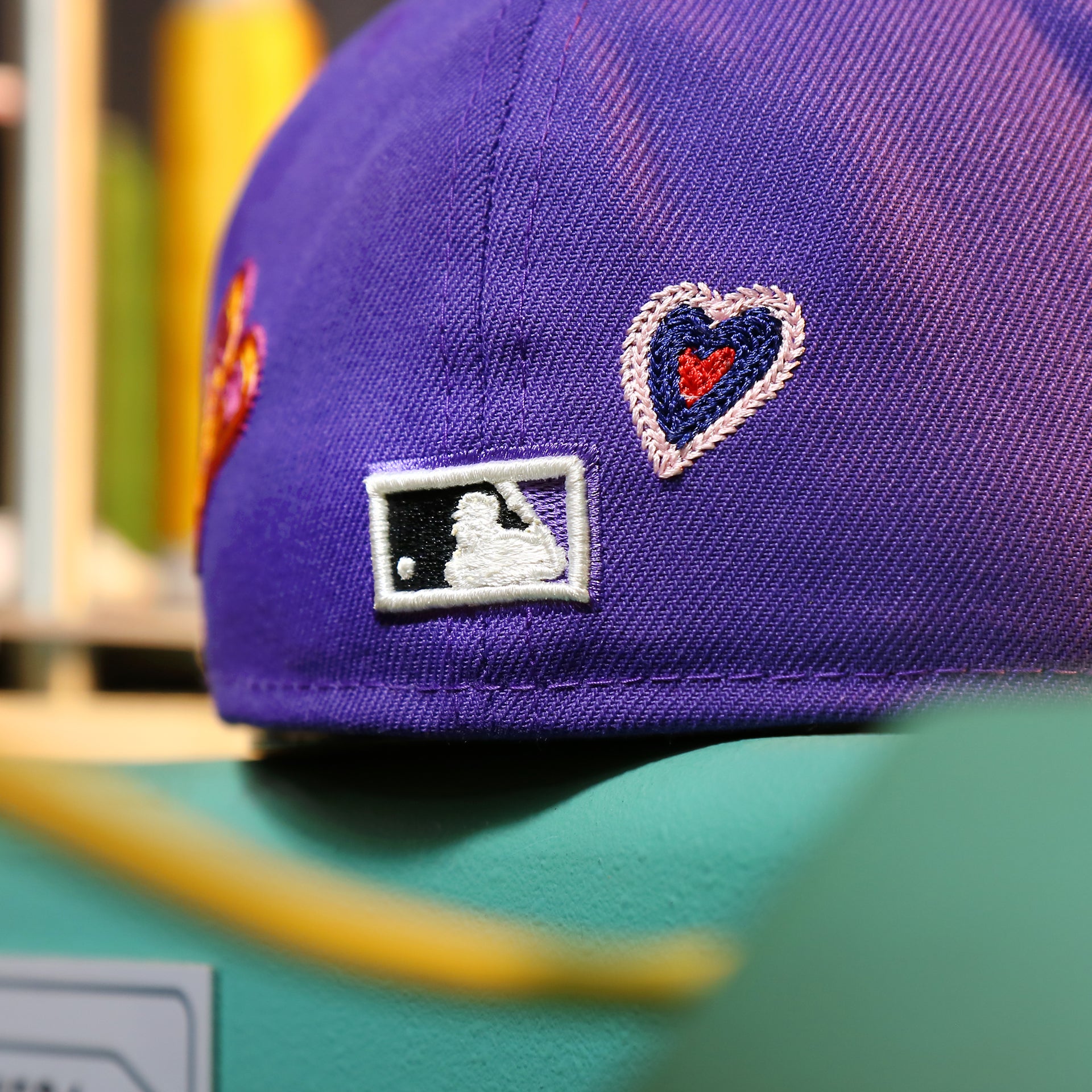 The MLB Batterman Logo on the Cooperstown Arizona Diamondbacks All Over Embroidered Chain Stitch Heart Pink Bottom 59Fifty Fitted Cap | Purple 59Fifty Cap