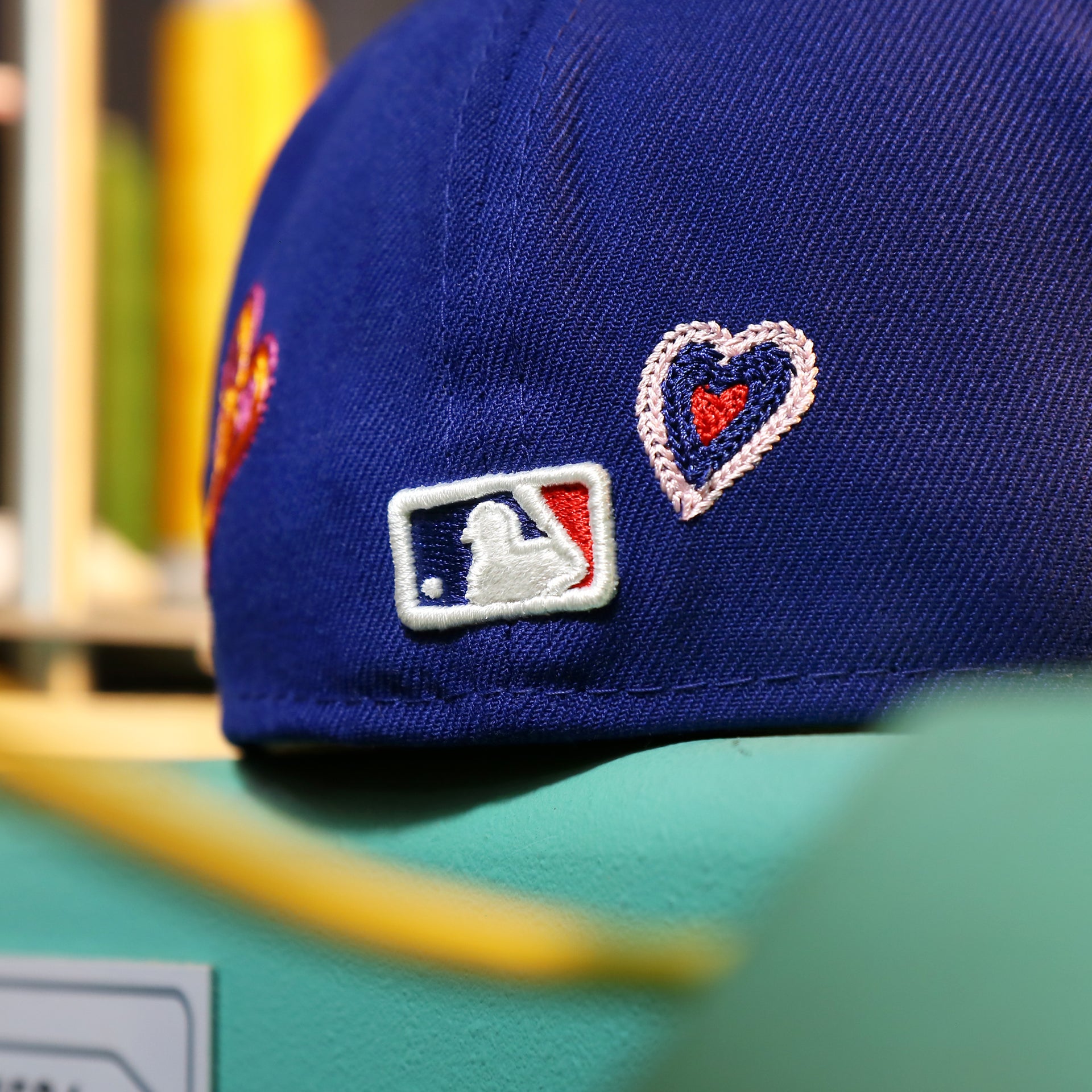 The MLB Batterman Logo on the Los Angeles Dodgers All Over Embroidered Chain Stitch Heart Pink Bottom 59Fifty Fitted Cap | Royal Blue 59Fifty Cap