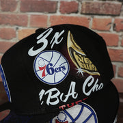 wearer's left of the Philadelphia 76ers “NBA Shirt Remix” All Over Print NBA Finals Champions Snapback Hat