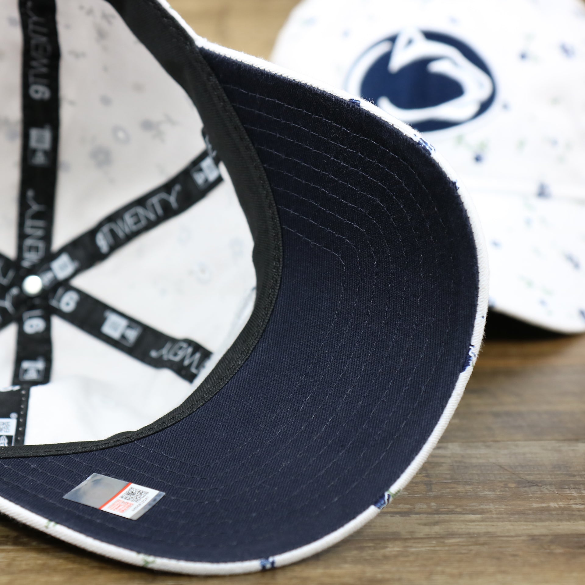 The Navy Blue Undervisor on the Women’s Penn State Nittany Lions All Over Micro Floral Print 9Twenty Dad hat | White 9Twenty Hat