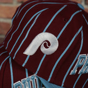 phillies logo on the Cooperstown Philadelphia Phillies City Arch Striped 9Fifty Snapback Cap | Maroon 9Fifty Cap