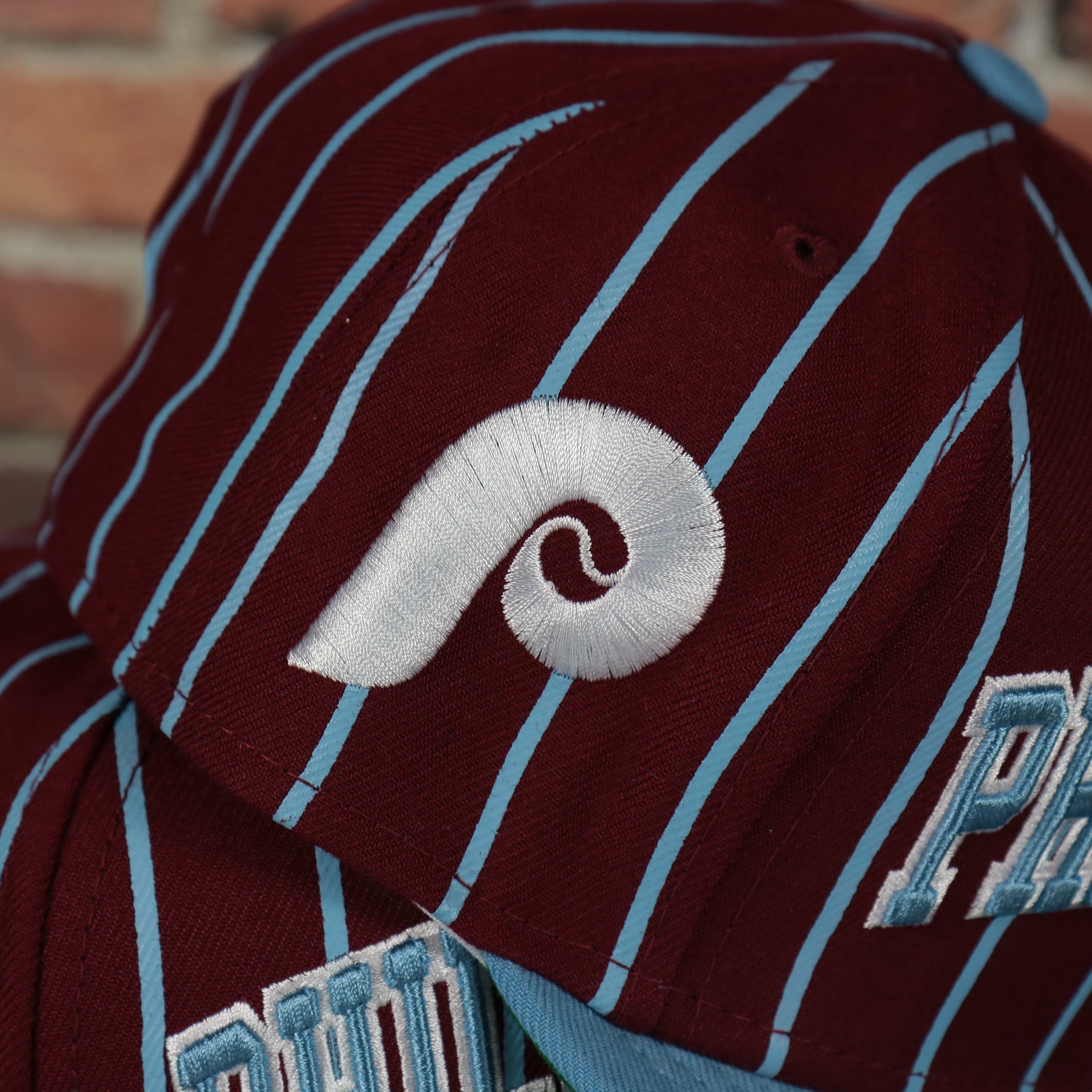 phillies logo on the Cooperstown Philadelphia Phillies City Arch Striped 9Fifty Snapback Cap | Maroon 9Fifty Cap