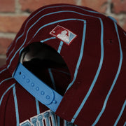 sky blue snap on the Cooperstown Philadelphia Phillies City Arch Striped 9Fifty Snapback Cap | Maroon 9Fifty Cap