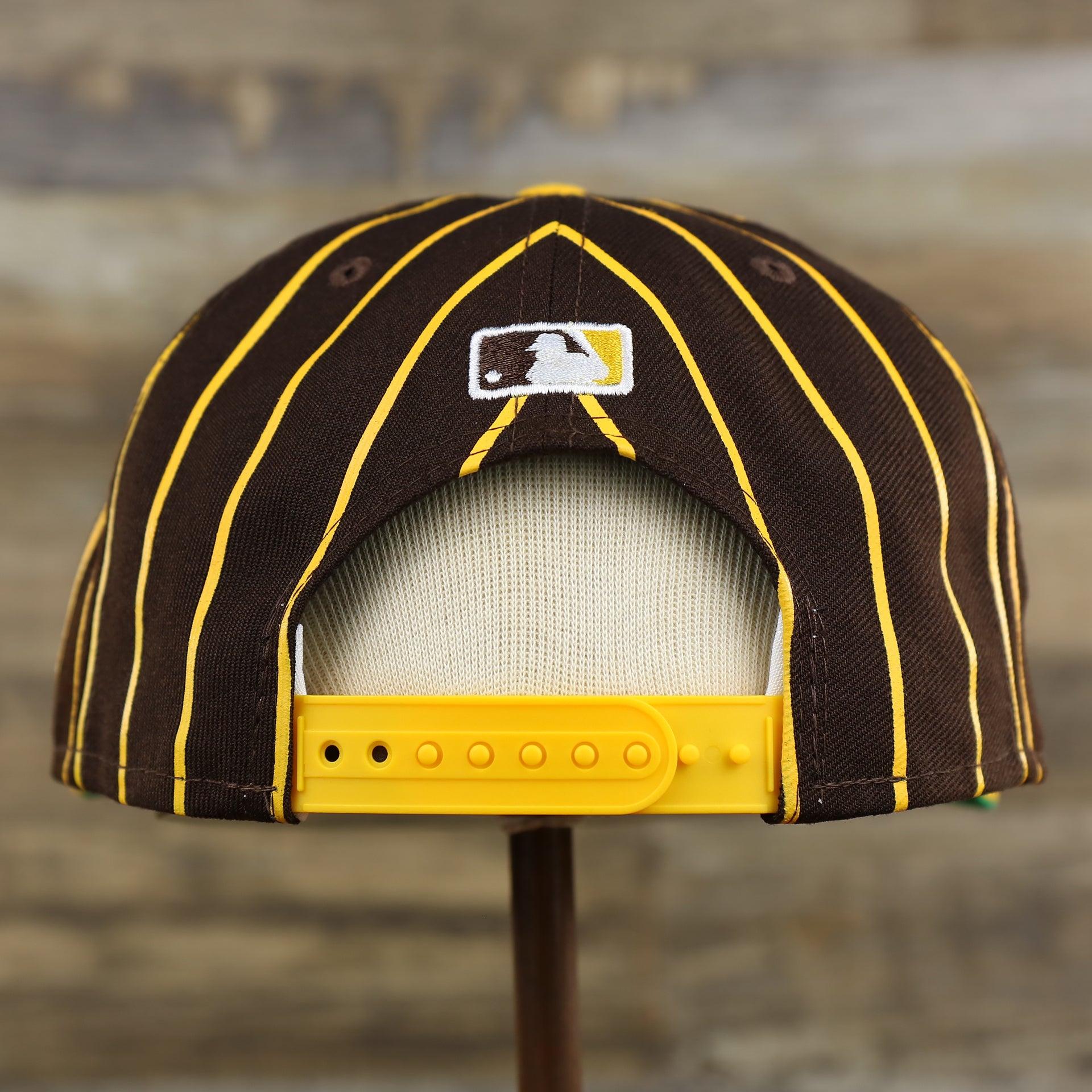 The backside of the San Diego Padres City Arch Pinstriped 9Fifty Snapback Cap | Brown 9Fifty Cap