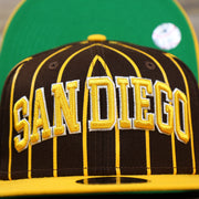The San Diego Wordmark on the San Diego Padres City Arch Pinstriped 9Fifty Snapback Cap | Brown 9Fifty Cap