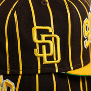 The San Diego Logo Patch on the San Diego Padres City Arch Pinstriped 9Fifty Snapback Cap | Brown 9Fifty Cap
