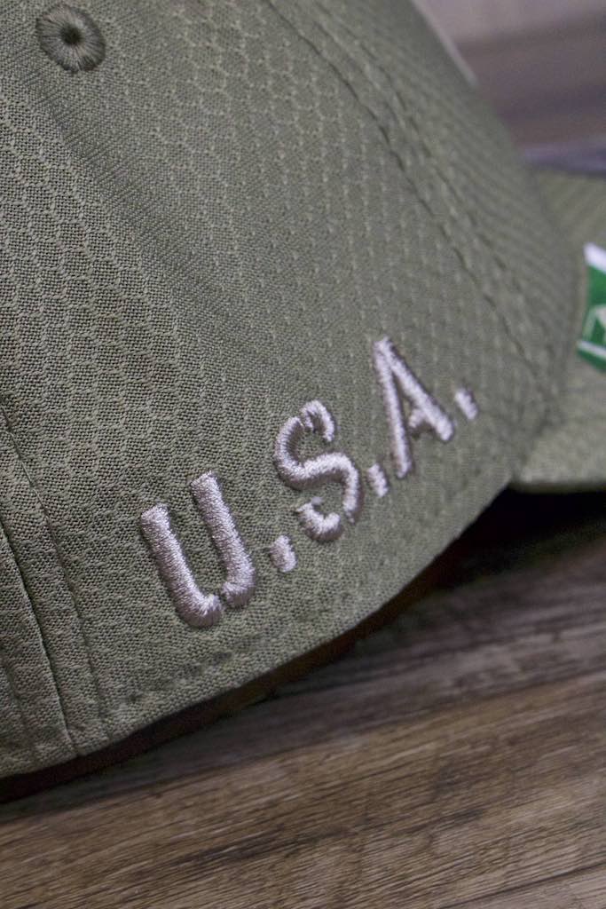 the letters USA on the New York Giants 2019 Salute to Service Dad Hat | Olive Green NFL On Field NY Giants Baseball Cap are embroidered on honeycomb nylon fabric