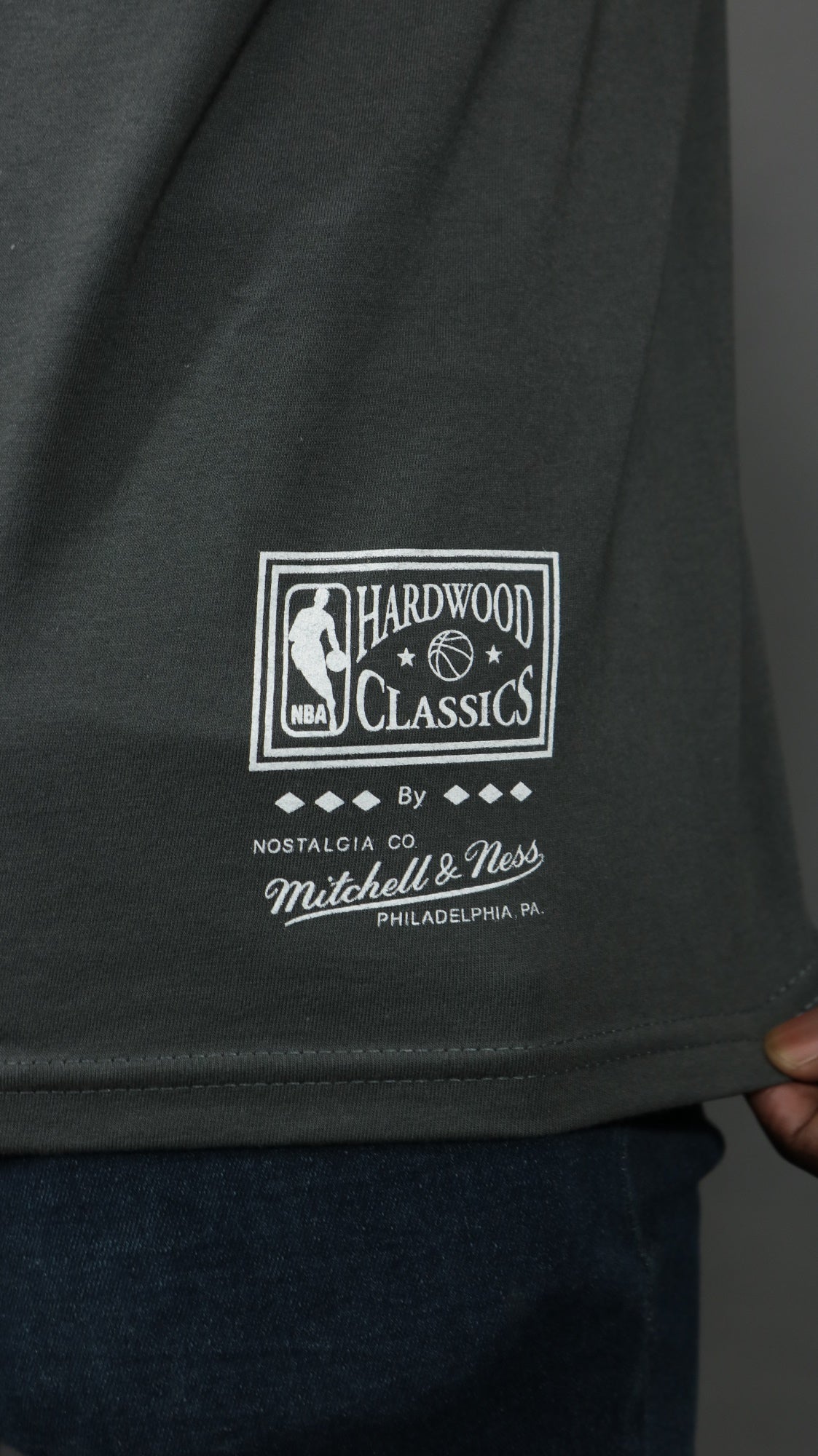 nba label on the Philadelphia 76ers NBA Hardwood Classics Vintage Cracked Tee | Charcoal Grey T-shirt