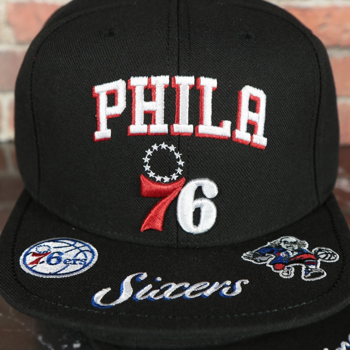 front loaded logos on the Philadelphia 76ers NBA Front Loaded "Sixers" script Green bottom Black Snapback Hat | Mitchell and Ness Snapback Cap