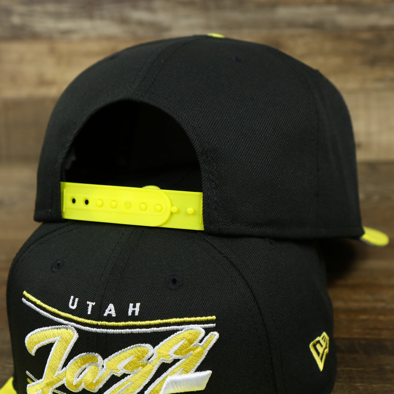 The backside of the Utah Jazz Team Script Gray Bottom 9Fifty Snapback | Black and Yellow Snap Cap