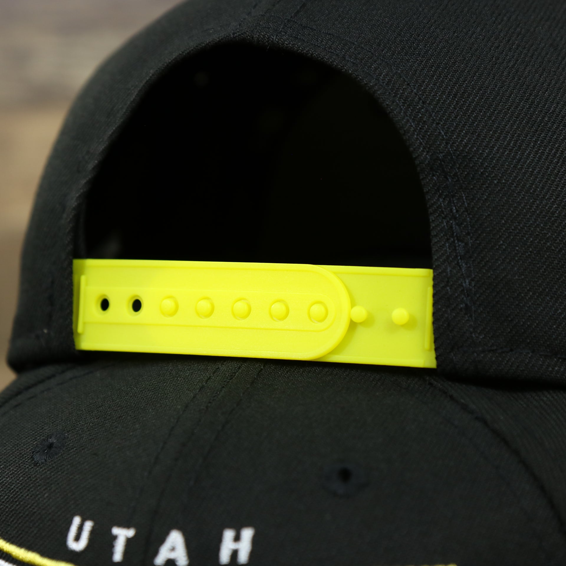 The Yellow adjustable strap on the Utah Jazz Team Script Gray Bottom 9Fifty Snapback | Black and Yellow Snap Cap