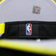 The NBA tag on the Utah Jazz Team Script Gray Bottom 9Fifty Snapback | Black and Yellow Snap Cap