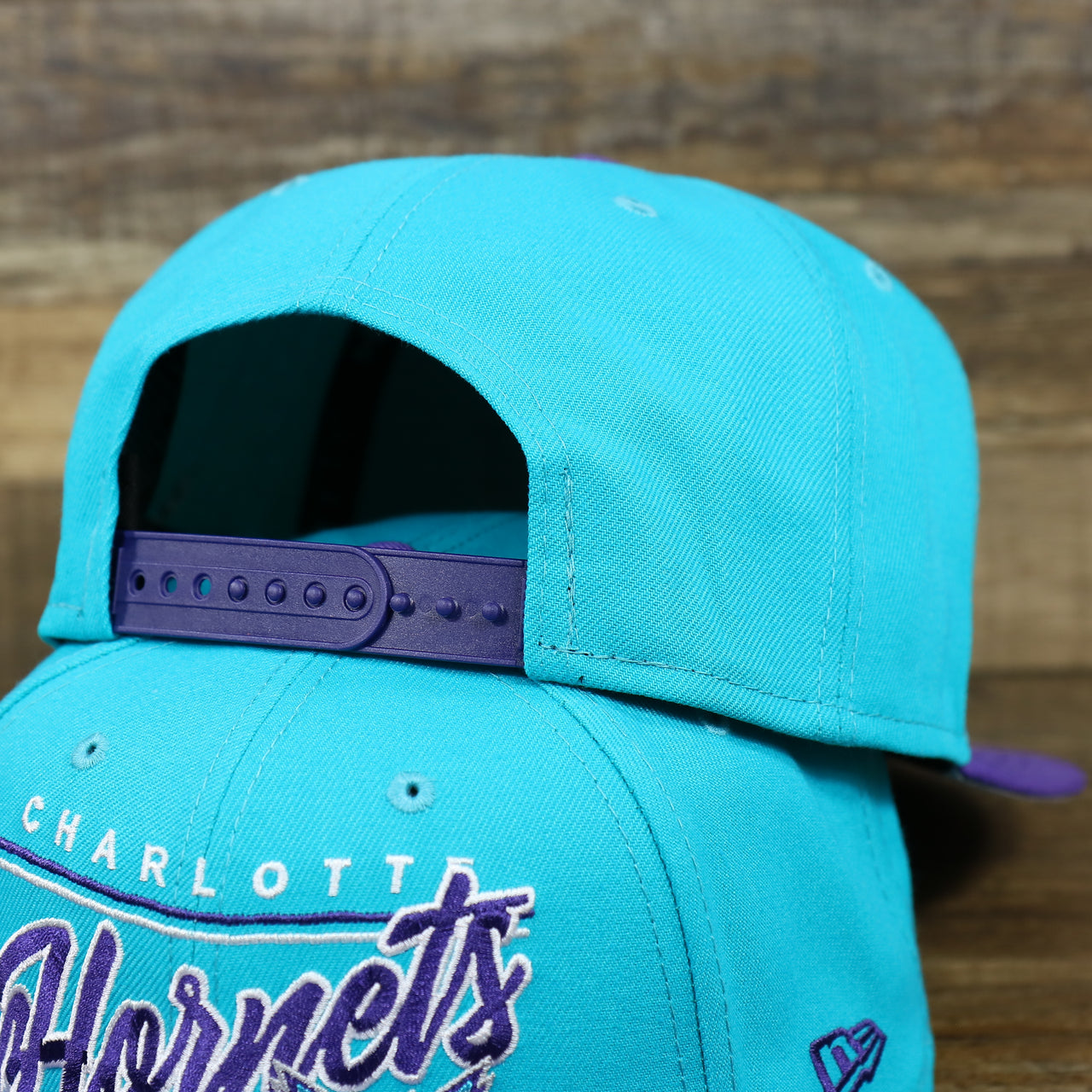 The Backside of the Charlotte Hornets Team Script Gray Bottom 9Fifty Snapback | Turquoise and Purple Snap Cap
