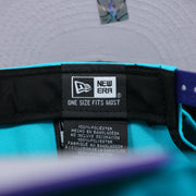 The New Era tag of the Charlotte Hornets Team Script Gray Bottom 9Fifty Snapback | Turquoise and Purple Snap Cap