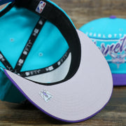 The Gray undervisor on the Charlotte Hornets Team Script Gray Bottom 9Fifty Snapback | Turquoise and Purple Snap Cap
