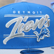 The Detroit Lions Team Script on the Detroit Lions Team Script Gray Bottom 9Fifty Snapback | Blue and Gray Snap Cap