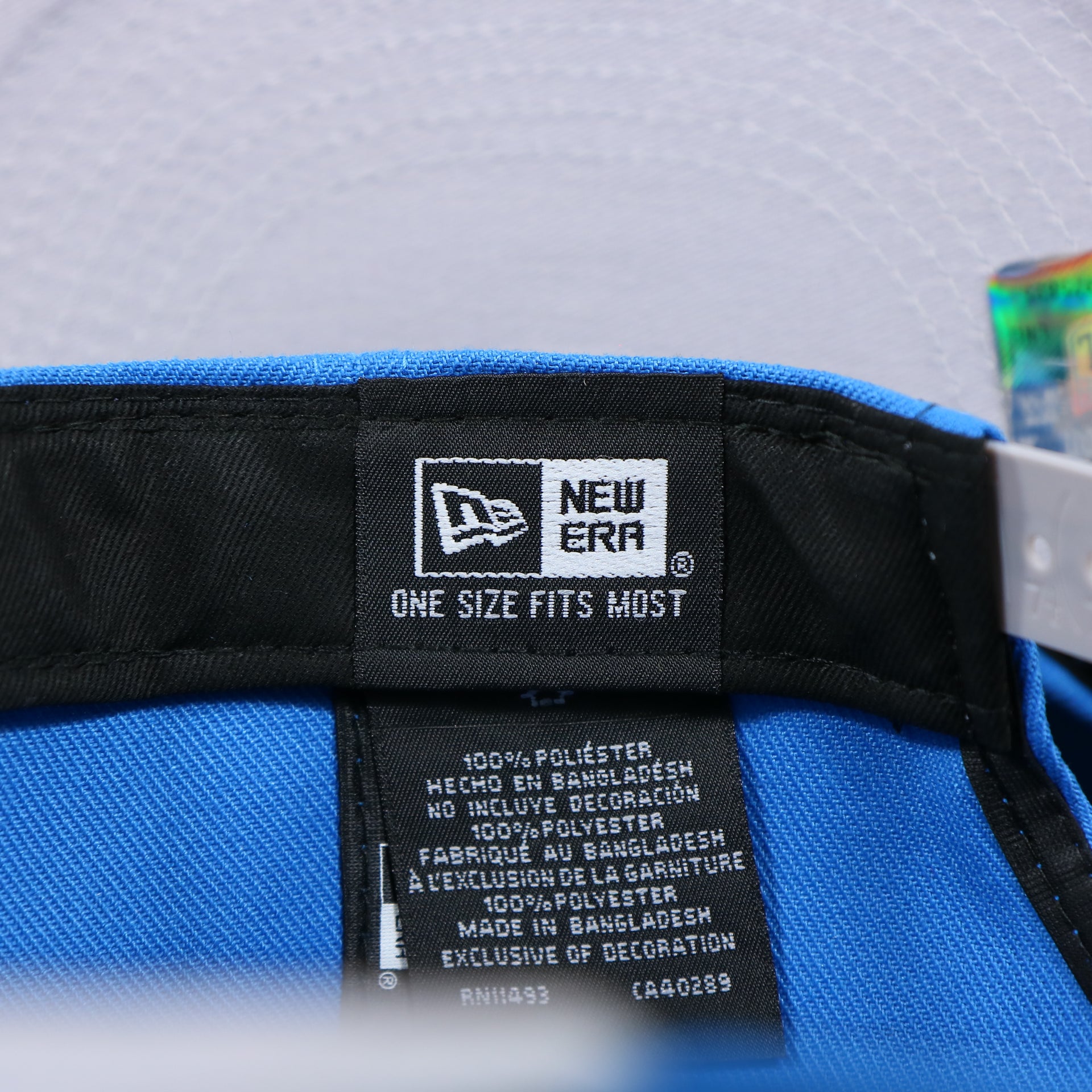 The New Era Tag on the Detroit Lions Team Script Gray Bottom 9Fifty Snapback | Blue and Gray Snap Cap